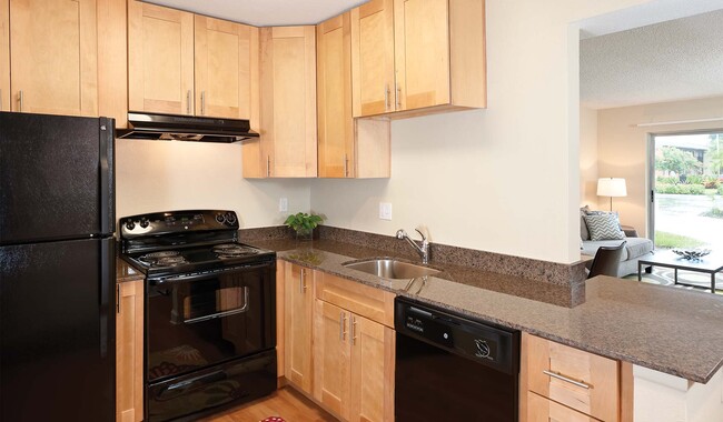 Kitchens features tone countertops and updated appliances. - Plantation Gardens Apartment Homes