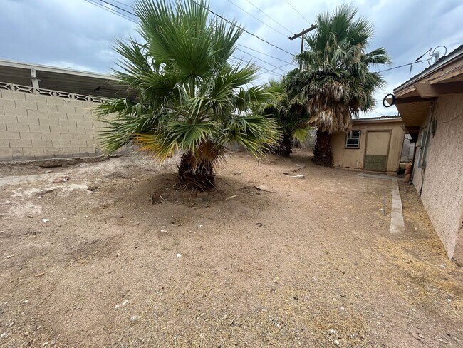 Building Photo - Single story home with large backyard and huge carport with plenty of storage.