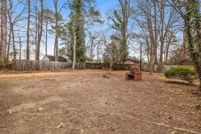 Building Photo - Brick home, Two Story, Hardwoods, DR, 2 Sun Rooms, FP, Carport!.