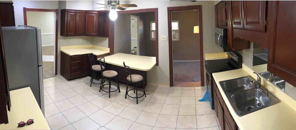 Kitchen looking to a sunken den used as the dining room in the past - 4968 New Haven Ave