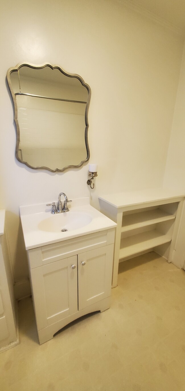 More bathroom storage behind the door. - 1229 N Orange Grove Ave