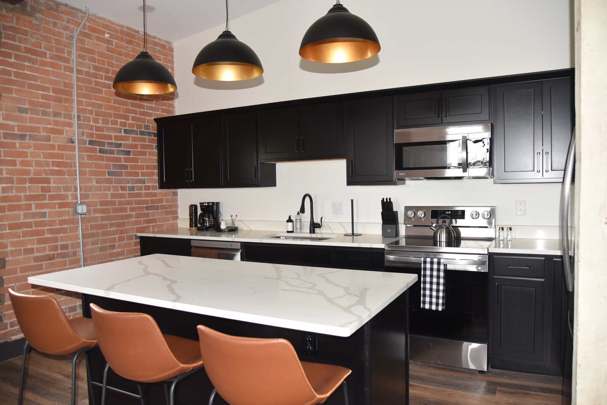 Fully furnished kitchen stocked with all standard and necessary cooking utensils. - 101 W Broadway St