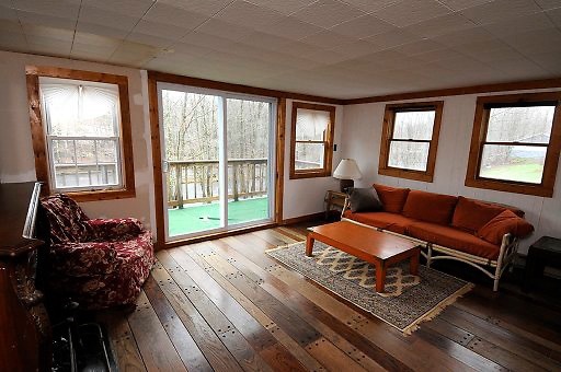 Living room with balcony overlooking river - 6201 NY-42