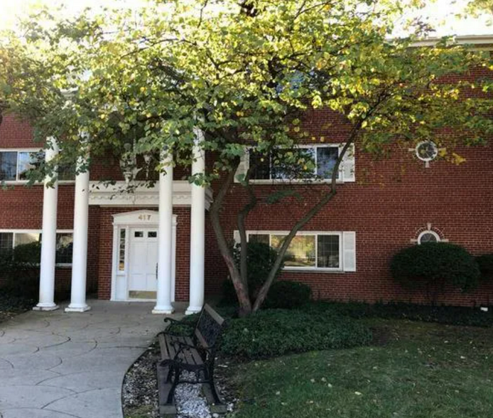 Brick, low-rise building on quiet street - 417 W Miner St