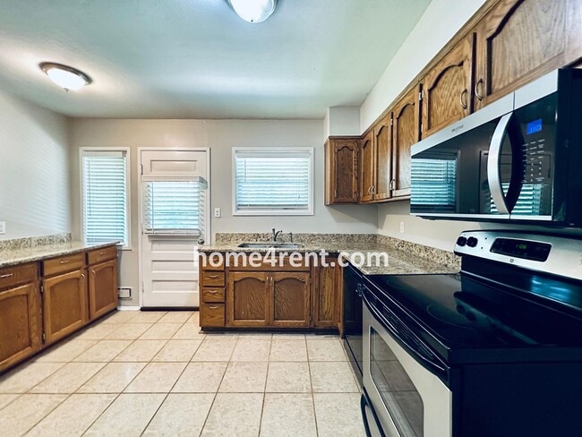 Building Photo - Attractive Prairie Village Ranch w/ FRESH PAINT, Wood Floors, Granite Counters and a Fenced Yard!