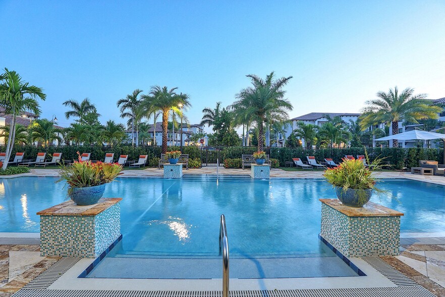 Lounge at the pool under our mature palm trees. - Windsor at Delray Beach