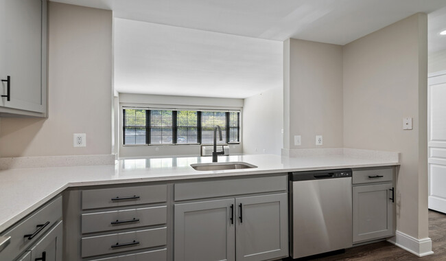 Select homes feature upgraded kitchens with quartz countertops and wood flooring - The Residences at Capital Crescent Trail