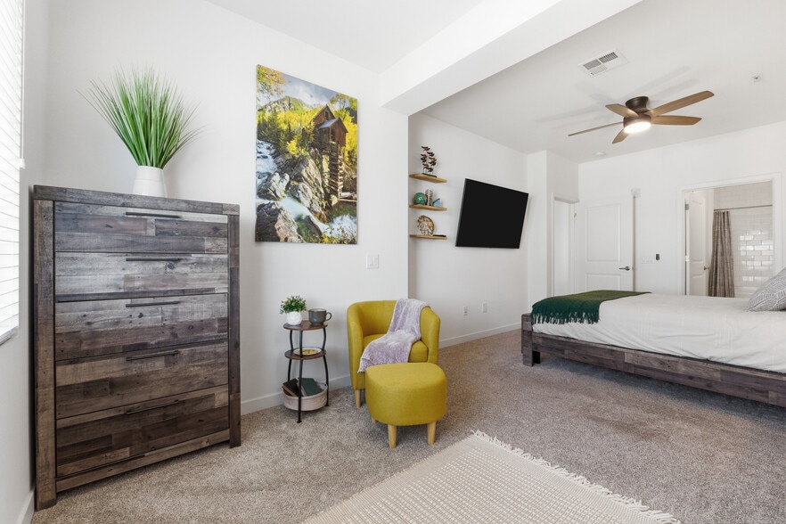 Spacious primary suite with plush bedding and thoughtful touches. - 2511 W Queen Creek Rd