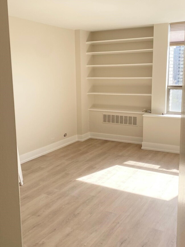 Bedroom with shelving and air conditioner - 1460 N Sandburg Ter