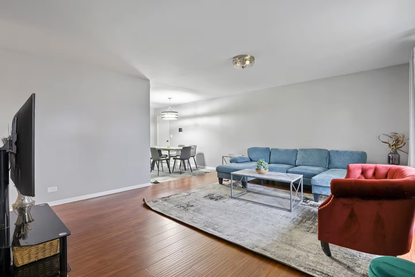 Living room with sleeper couch, smart TV and closet space. - 1002 Juniper Ln