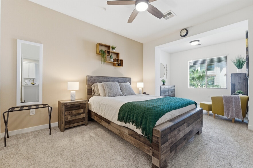 Spacious primary suite with plush bedding and thoughtful touches. - 2511 W Queen Creek Rd