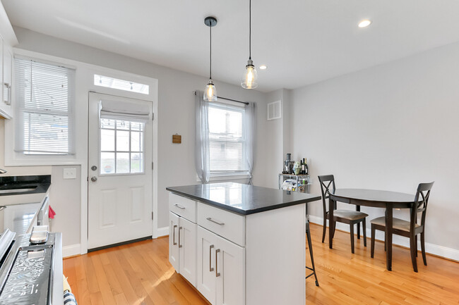 Kitchen with backdoor leading to porch. - 123 36th St NE