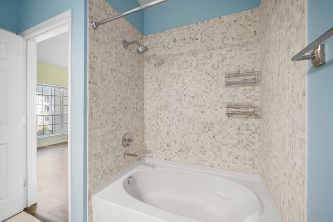 Building Photo - Two-bedroom, two-bathroom model with a den, located on the third floor.