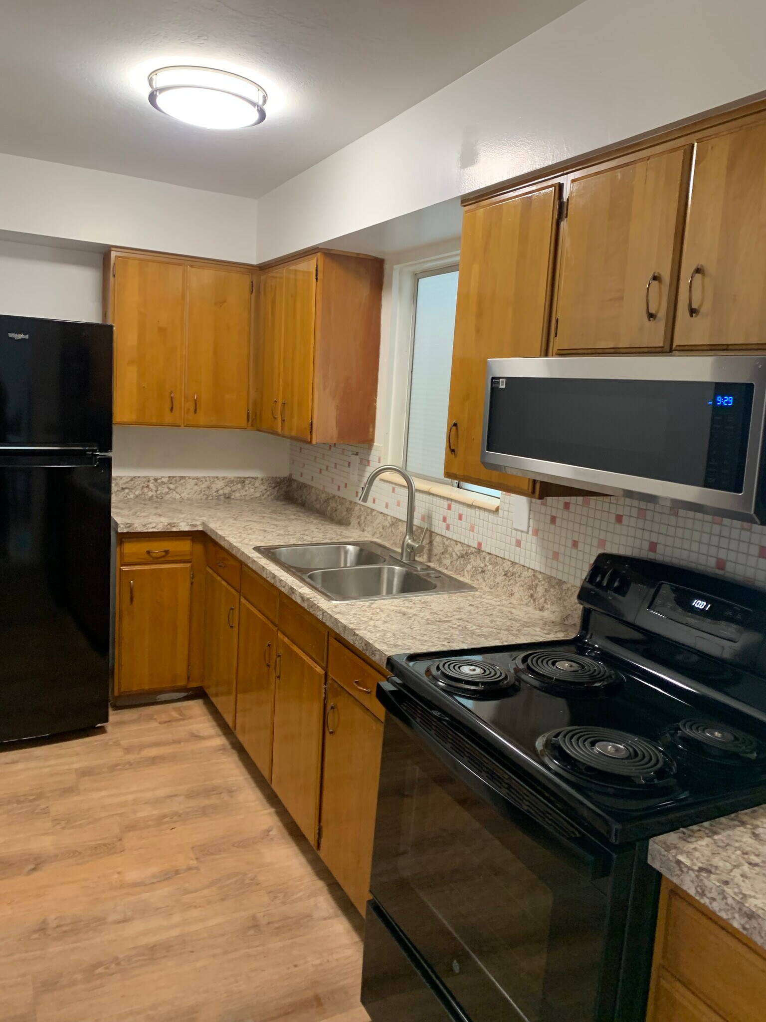 Newly remodeled kitchen with new appliances, refrigerator, stove, and microwave. - 886 Raymond Dr