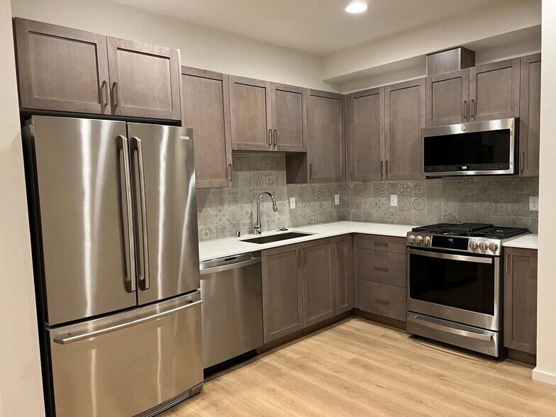 Kitchen: Quartz countertops and stainless-steel appliances - 3631 1st Ave NW