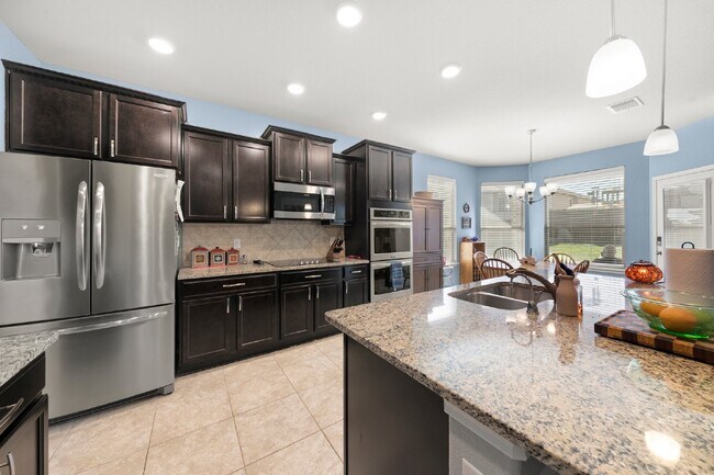 Building Photo - Spacious 5-Bedroom Home with Granite Count...