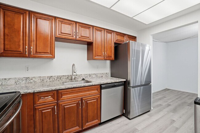 Building Photo - This expansive ground level residence is set within a serene, gated garden community surrounded b...