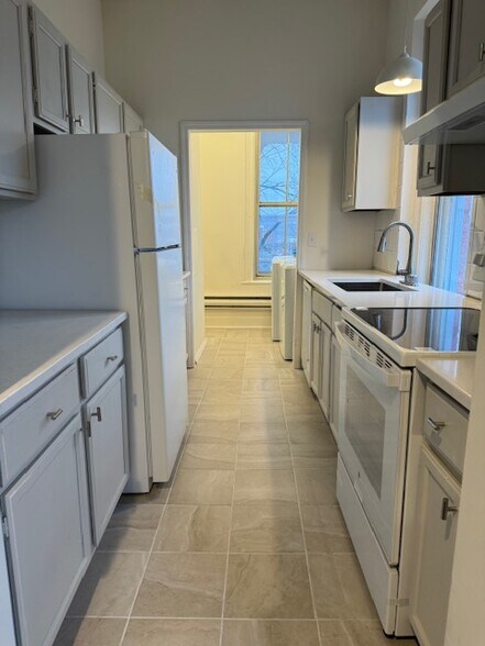 Kitchen boasts new countertops, tile floor and appliances - 118 Philip St