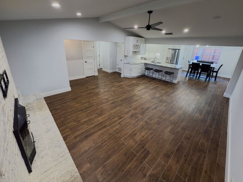 Living room flowing into the updated kitchen with white cabinetry - 2006 Candle Ct