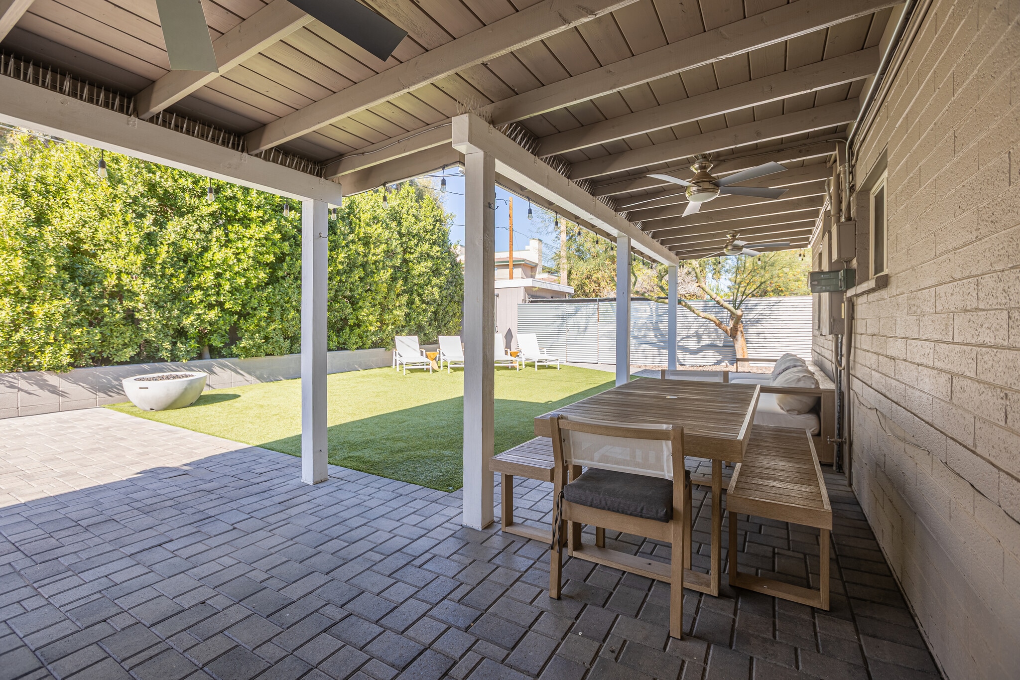 Large covered patio with ceiling fans and West Elm outdoor furnishings - 6136 N 9th St