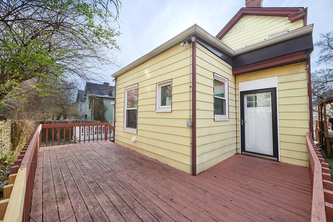 Large back deck with access off of the kitchen or the side of the house with electric outlets - 2354 Victor St