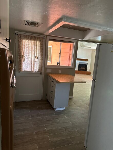 Kitchen, looking into living room and back door - 1315 E Adams St