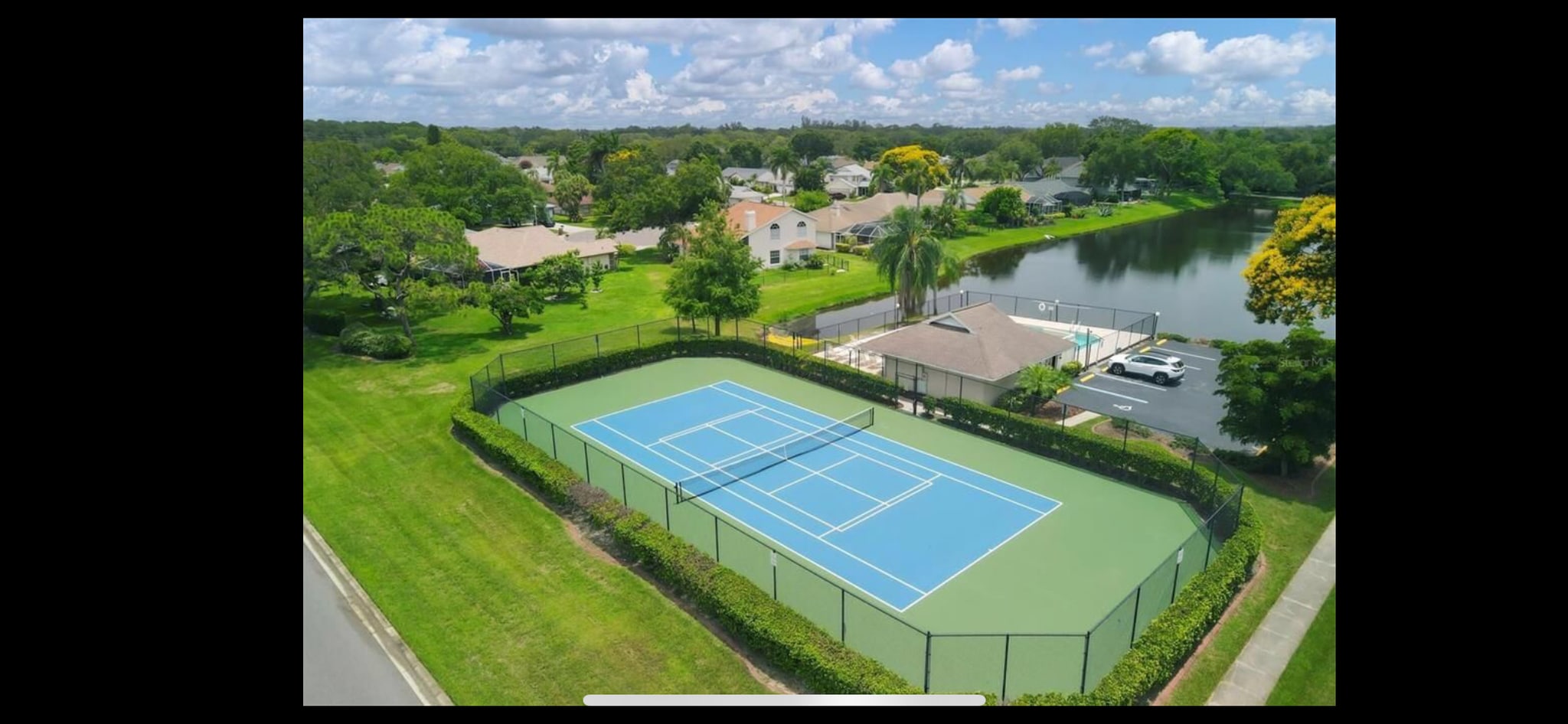 AerialCommunity pool with tennis court and clubhouse - 5714 29th Ct E