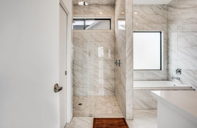 Master shower with regular shower head and waterfall shower head - 2307 N Carroll Ave