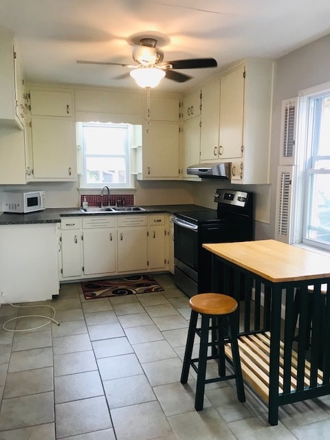 Kitchen with stainless side-by-side refrigerator and stove - 212 Evans St