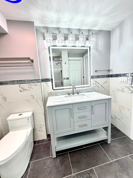 New vanity, marble counter, and faucet, as well as new toilet. - 16W671 56th St