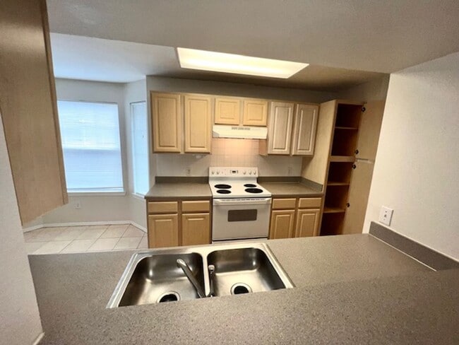 Building Photo - Move in NOW- Spacious 2 bedroom 1 bath condo on 3rd floor in gated community! Water included with...