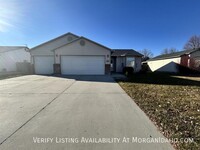 Building Photo - Three car garage, Fully fenced, Large back...