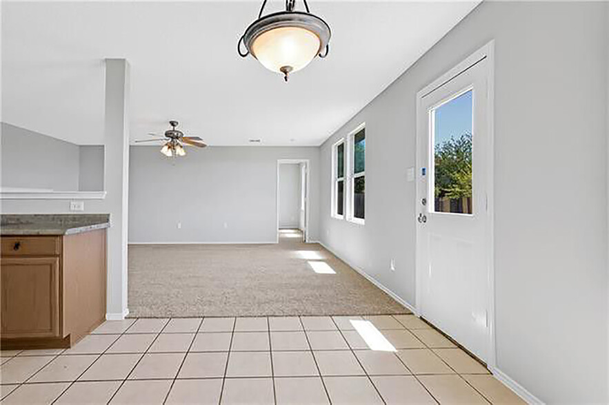Eat-in looking through living to master bedroom door. Woodgrain tile and granite not pictured. - 1419 Windy Meadows Dr