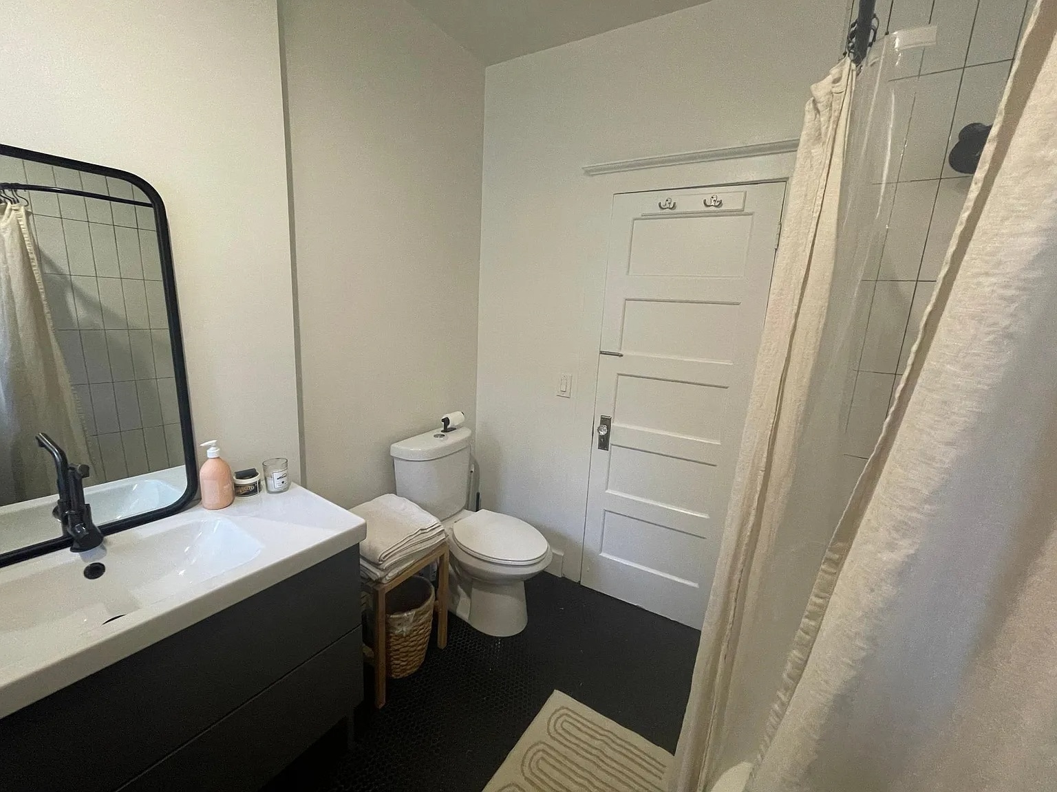 Clean and stylish bathroom with tile and matte black fixtures. - 6000 Carlton Way