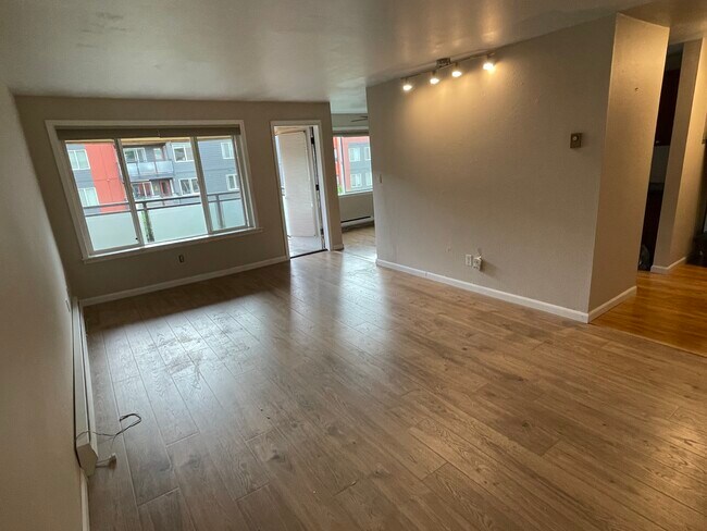living area (facing north-west). Front entry is to the right. Balcony beyond. - 7001 Sand Point Way NE