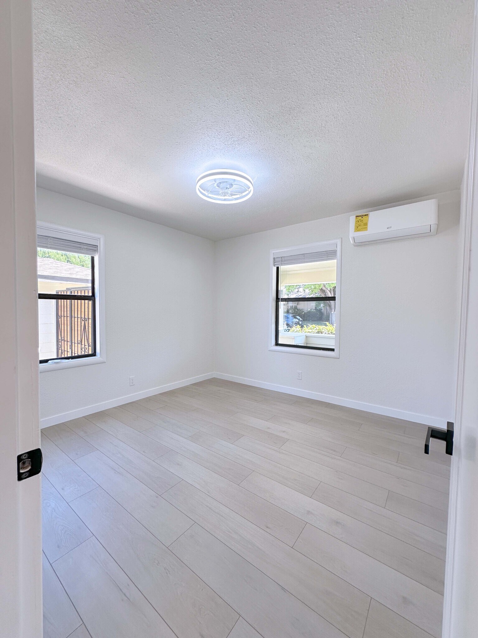Bright and airy Bedroom #1 with AC, spacious closet, and two large windows. - 4570 58th St