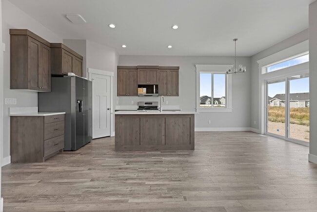 Building Photo - NEW HOME with large garage stalls and unfinished basement for additional storage