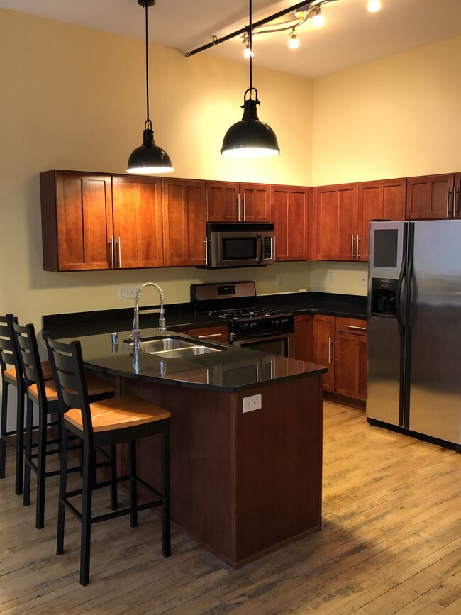 Kitchen - cherry wood cabinets, granite tops, maple flooring, and new dishwasher - 1017 S 2nd St