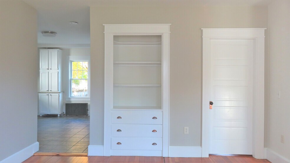 Looking from back parlor into kitchen, the back bedroom behind the closed door - 21 Courtland St