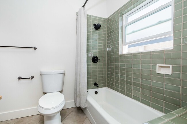 Bathroom with soaking tub / shower and linen closet. - 431 Athol Ave