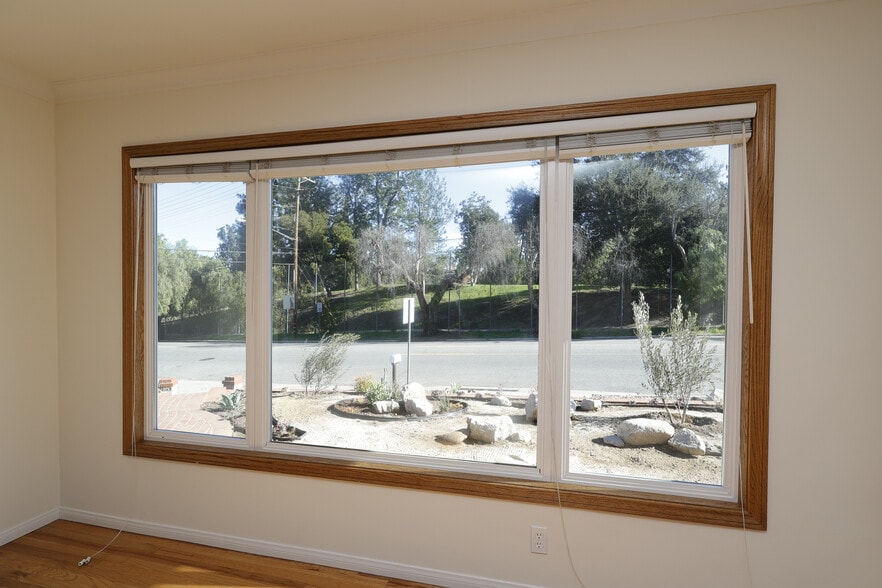 Big sound proof windows looking out onto the front rock garden and the greenery across. - 4831 Canoga Ave