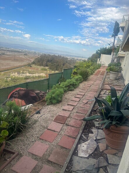 Tranquil walkways offering peaceful moments of reflection with sweeping views. - 8120 Billowvista Dr