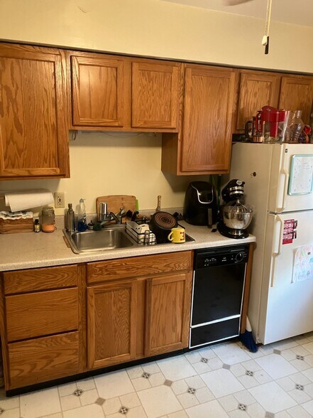 kitchen, stainless steel sink, disposal, dishwasher, freezer, and refrigerator - 17003 Hilliard Rd