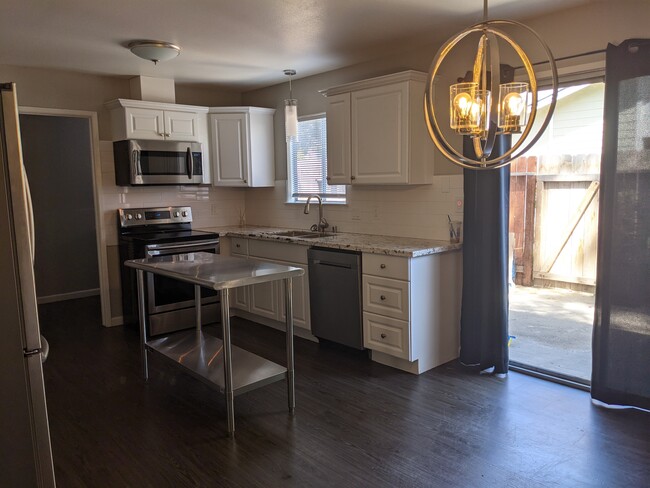 Kitchen has stainless steel Samsung appliances. - 4767 N Cedar Ave