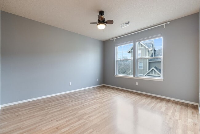 Building Photo - Lovely and bright townhouse with a hard wood flooring throughout, a 2 car garage, AC & more!