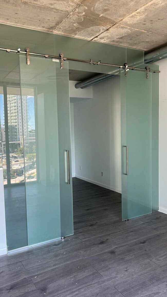 Bedroom is enclosed and frosted glass to ensure privacy and tranquility - 690 SW 1st Ct
