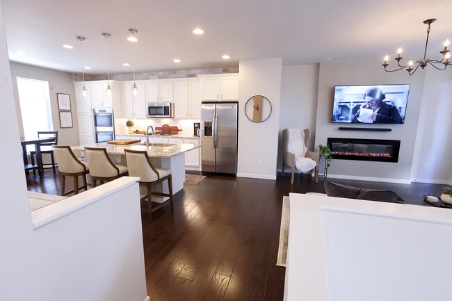 Main level open concept with kitchen and living room. - 15637 E Broncos Pl