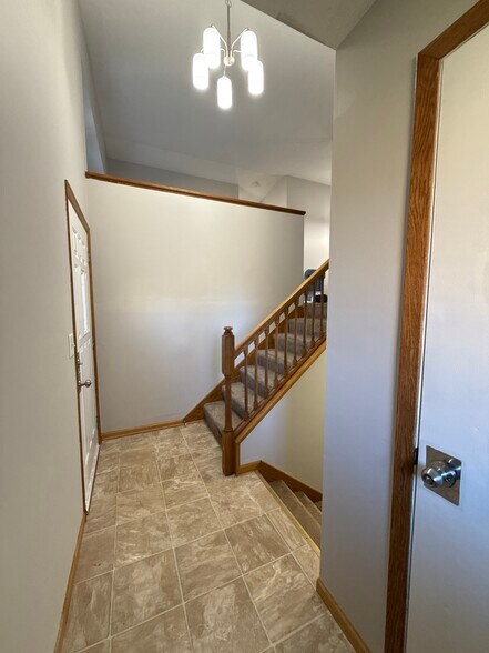 Bright entryway with updated lighting and easy access to both levels. - 9092 Goldenrod Ln N