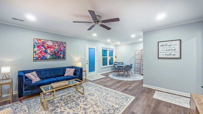 Living room/dining room opens to back deck, outdoor storage closet and wooded area - 107 Abbots Glen Ct