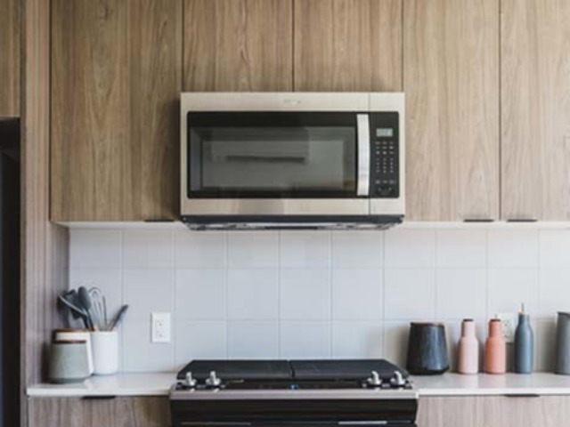 Close up of stainless steel appliances in kitchen - Modera Broadway